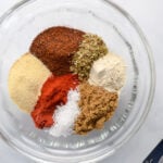 spices in a glass bowl with measuring spoon